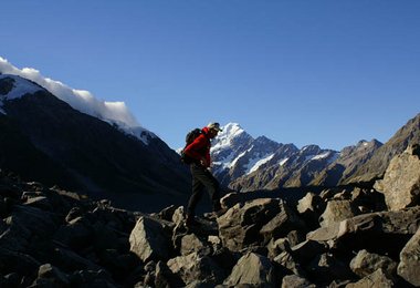 Gerhard Schaar - walking on a moraine - Hooker VAlley - Mt. Cook in background - Southern Alps - NZL